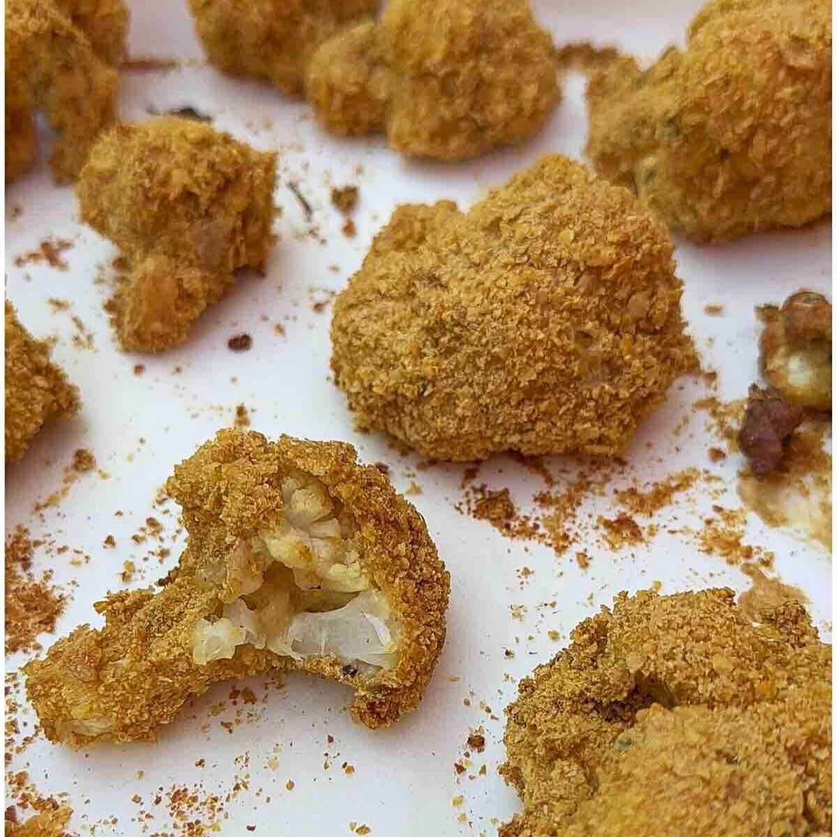 Crunchy Cauliflower Bites with a bite taken out of one.