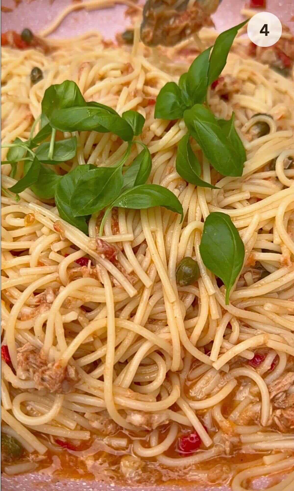 Tuna, caper & chilli spaghetti in a pan ready to be served.