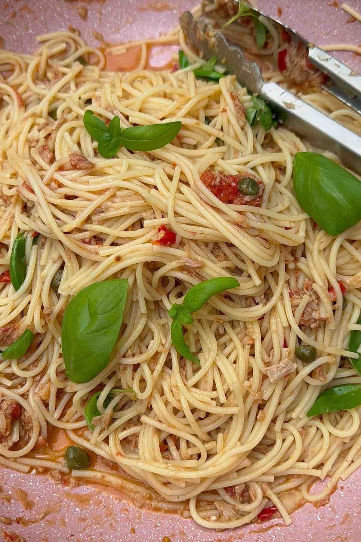 Tuna, caper & chilli spaghetti in a pan ready to be served
