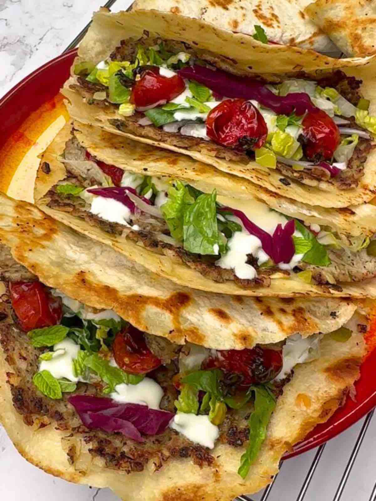 Juicy turkey mince patties seasoned with herbs and Baharat spice, topped with Greek yogurt, pickled cucumber, grilled cherry tomatoes, and more. 