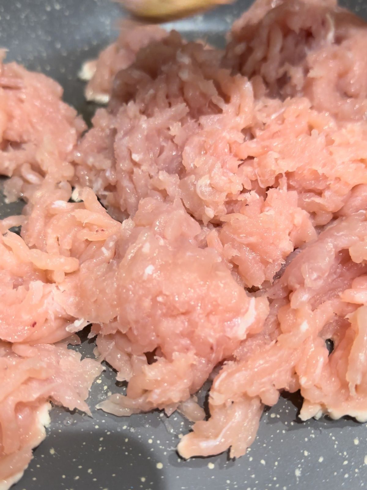 Pan with a splash of sunflower oil and finely chopped turkey mince meat, preparing Korean-style keema. 