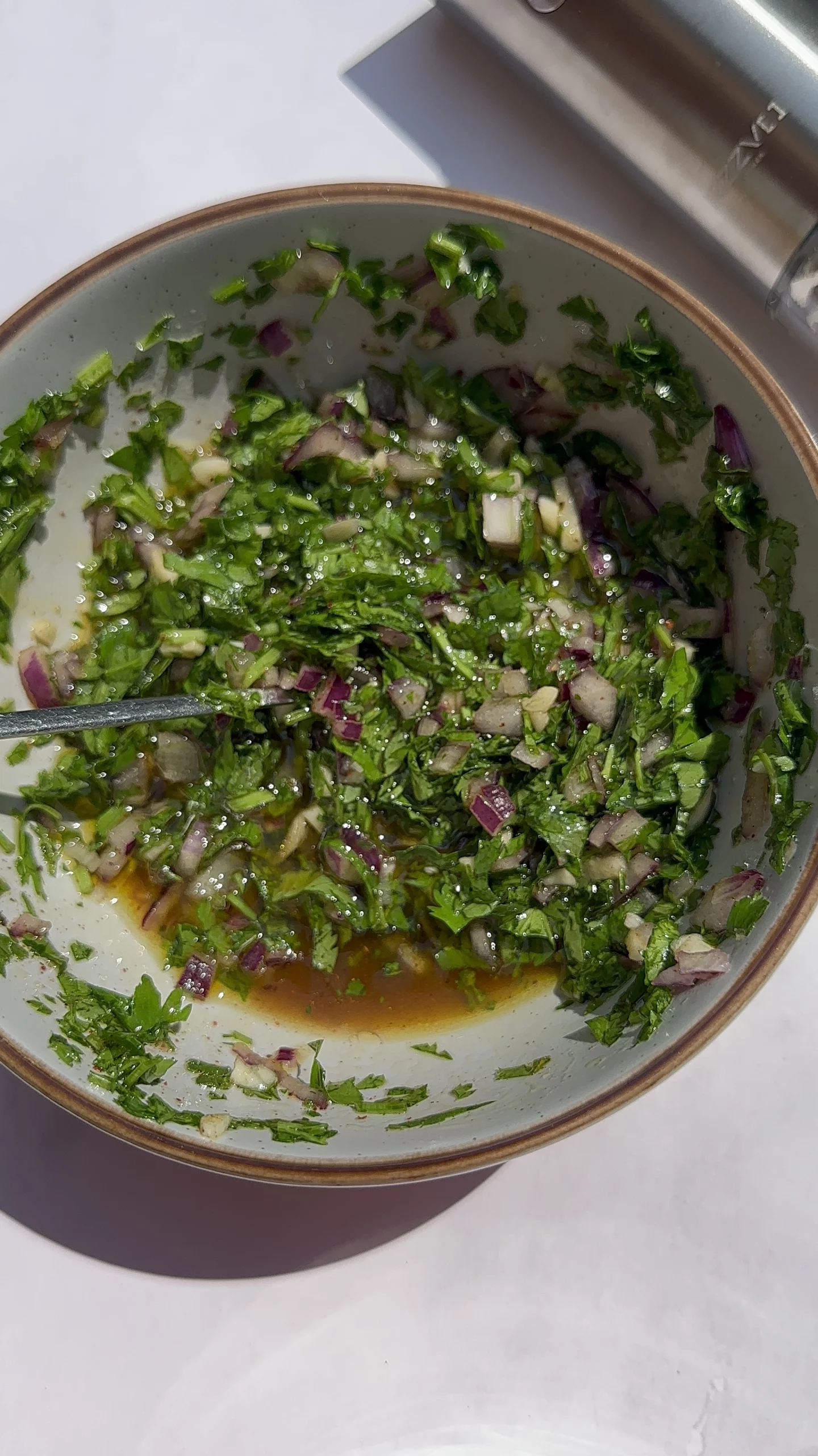 Chimichurri Sauce in a bowl with a spoon inside