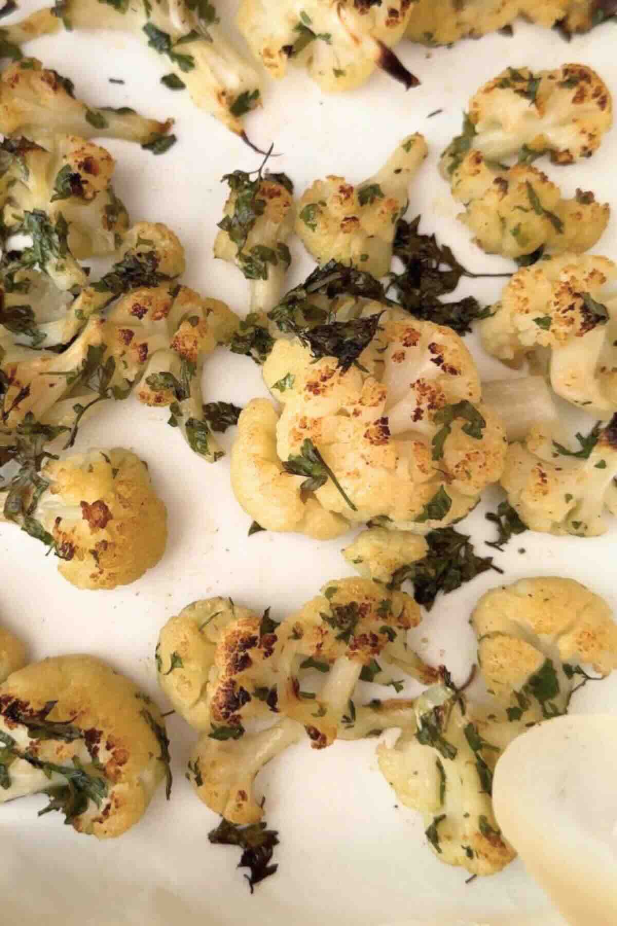 Baked cauliflower florets in a tray.