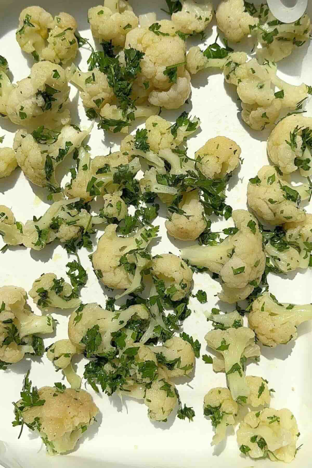 Cauliflower florets in a tray ready to be baked.