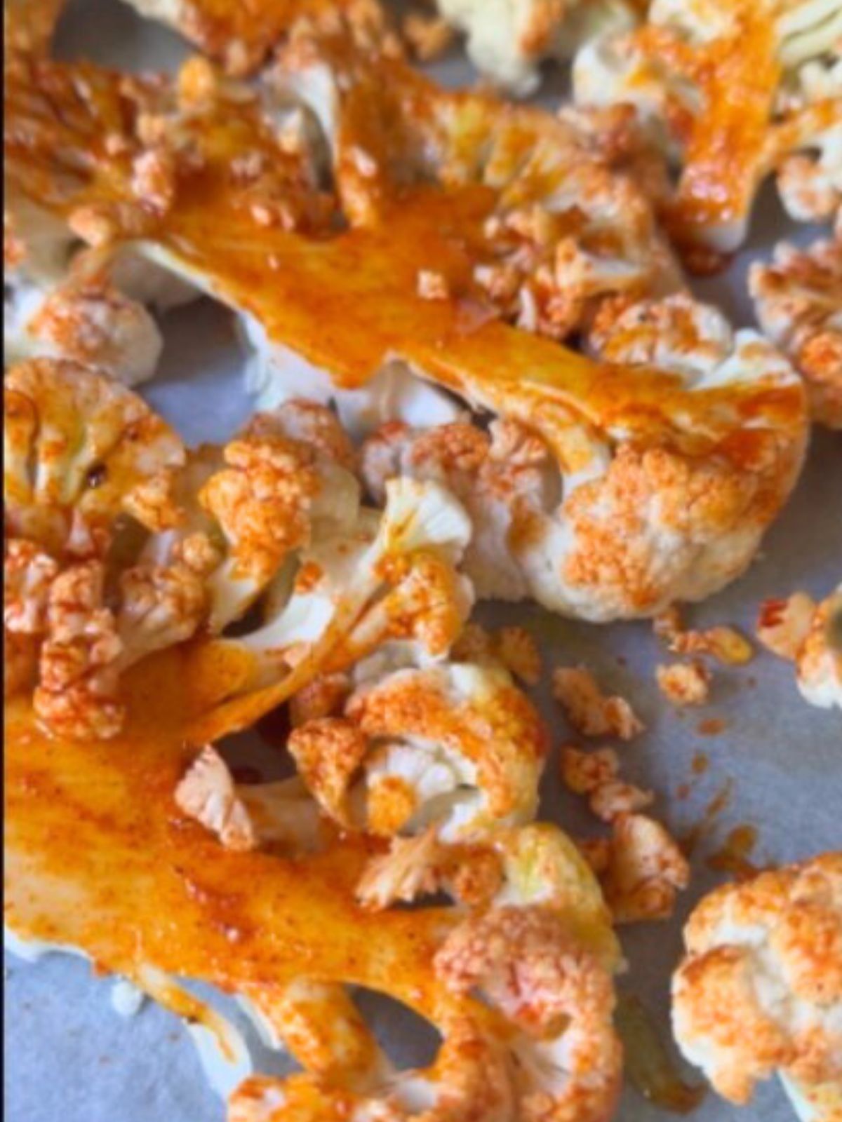Cauliflower steaks coated with a spice mix before roasting.