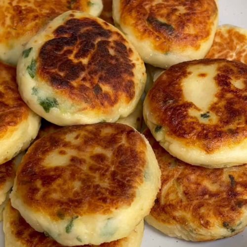 Golden-browned potato cakes layered onto a plate.