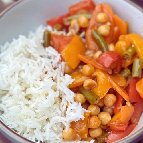 Bowl of Sweet and Sour Vegetable Stir Fry with rice.