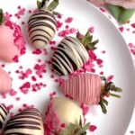 Chocolate-covered strawberries neatly arranged on a white plate, ready to serve.