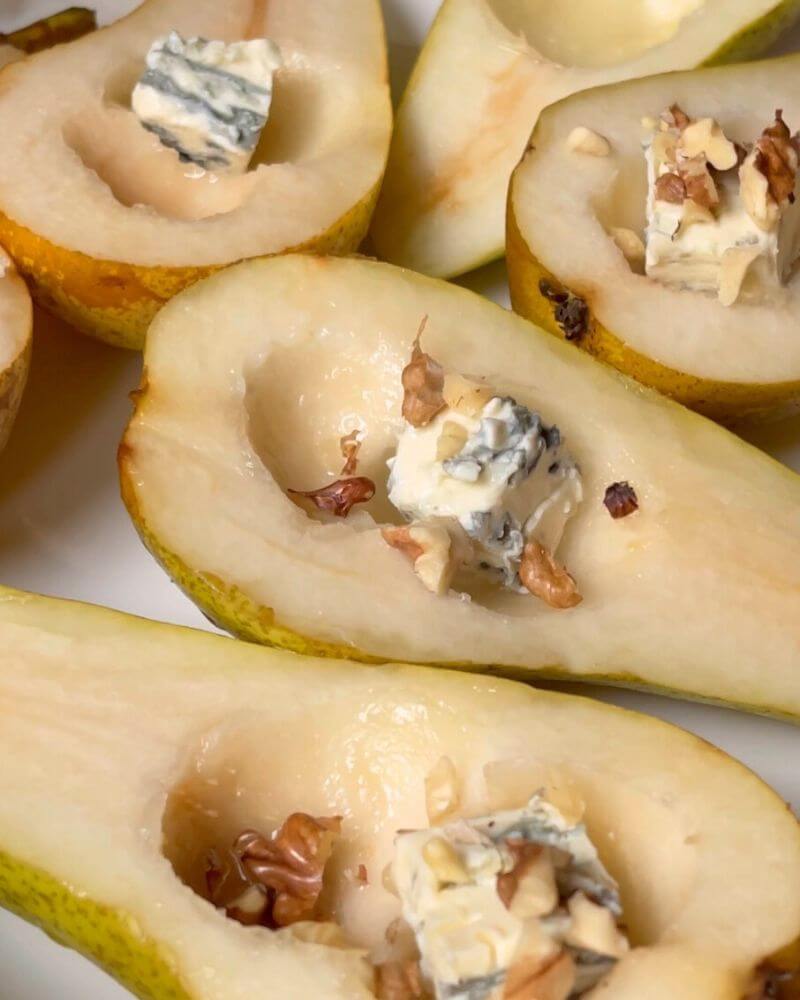 Chunks of Gorgonzola cheese and chopped walnuts added to pear halves. 