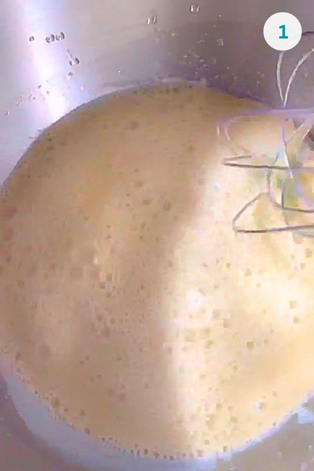 Mixed warm milk, sweetener, egg yolks, oil, and dissolved fresh yeast in a large bowl.