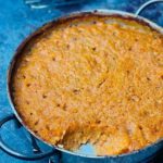 Romanian bean dip (fasole bătută) with caramelised onions, freshly baked in a pan with a crust on top.