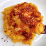 Tomato Chicken on top of mashed potatoes.