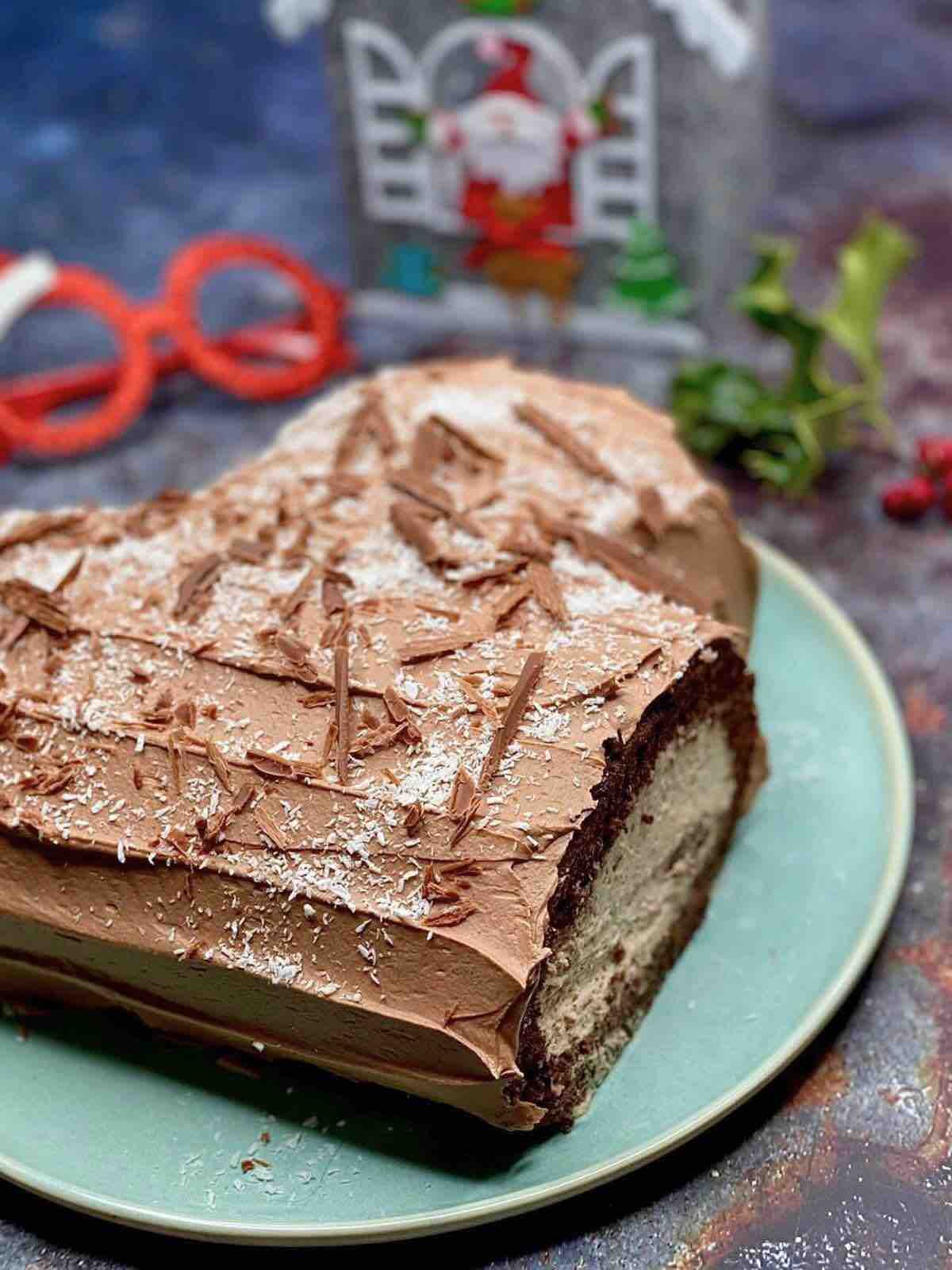 Christmas chocolate Swiss roll on a green dish