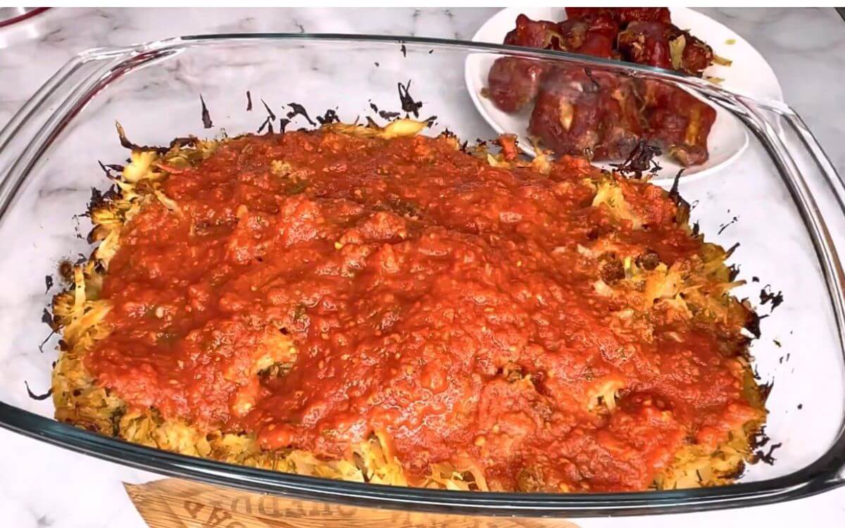 Tomato puree, herbs, and seasoning added to cabbage and ribs, ready to bake until tender.