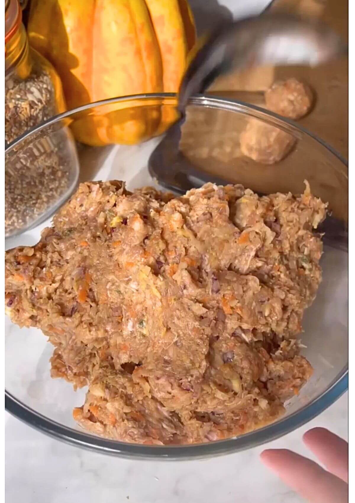 Meatball ingredients mixed in a bowl, ready for seasoning. 