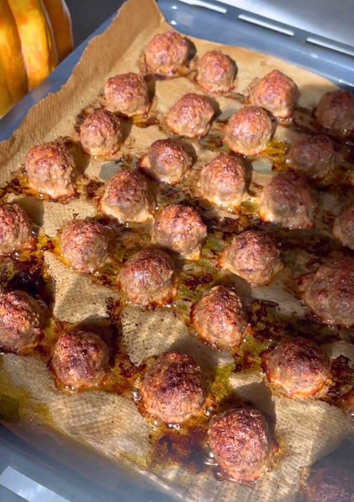 Baked meatballs until golden brown on a baking pan. 