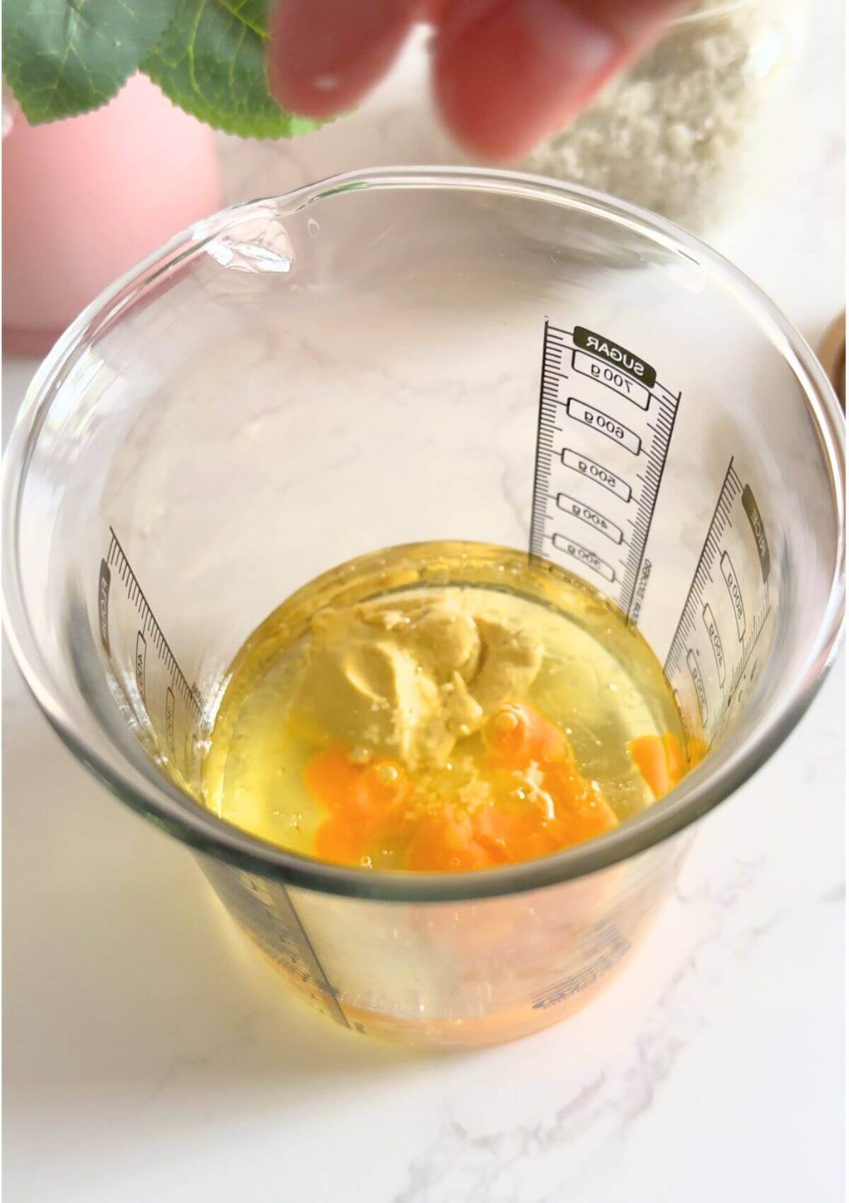 Sunflower oil, egg, mustard, lemon juice, and salt blended in a glass jar to make homemade mayo.
