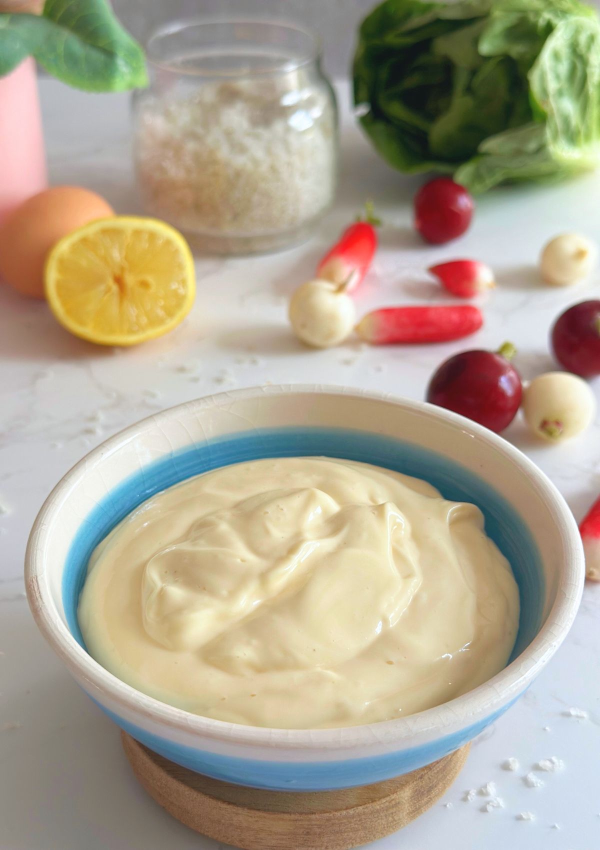 A bowl of 4-ingredient mayo with same vegetables in the background. 