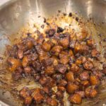 Sticky Chinese pork belly in a stainless steel pan.