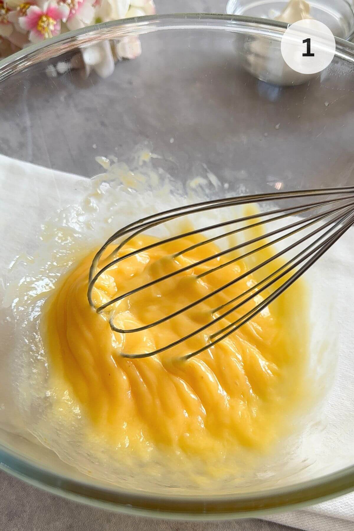 Whisk eggs in a bowl, add coconut oil, and warm the bowl if needed.