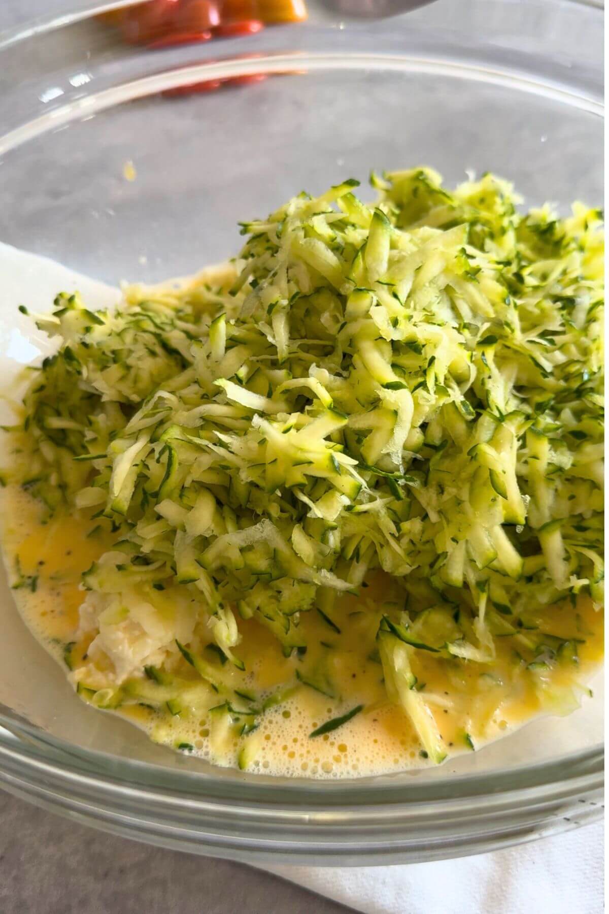 Preventing soggy egg muffins by draining zucchini.