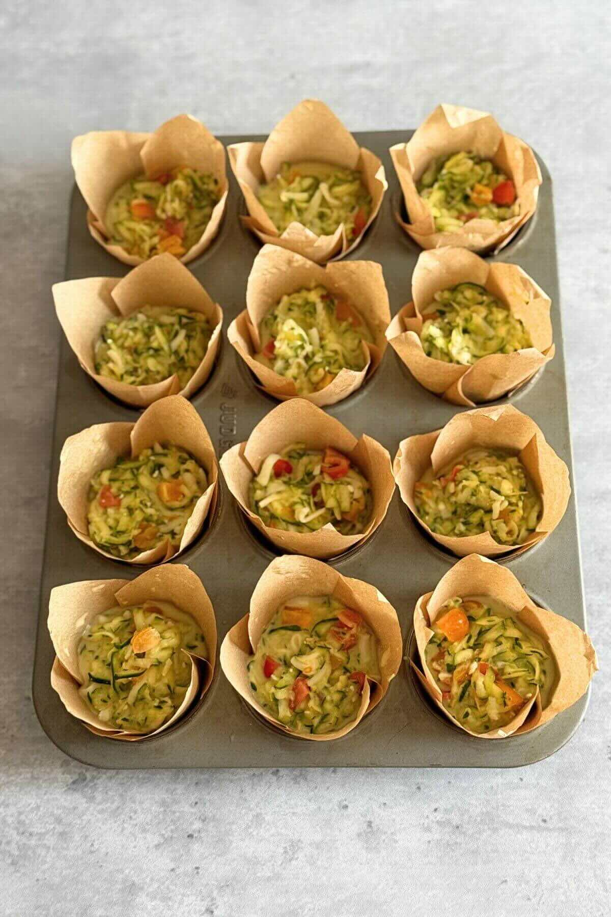 Preparing muffin tin for egg cups.