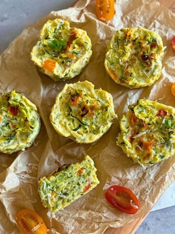 Gluten-free zucchini egg muffins on a wooden board.