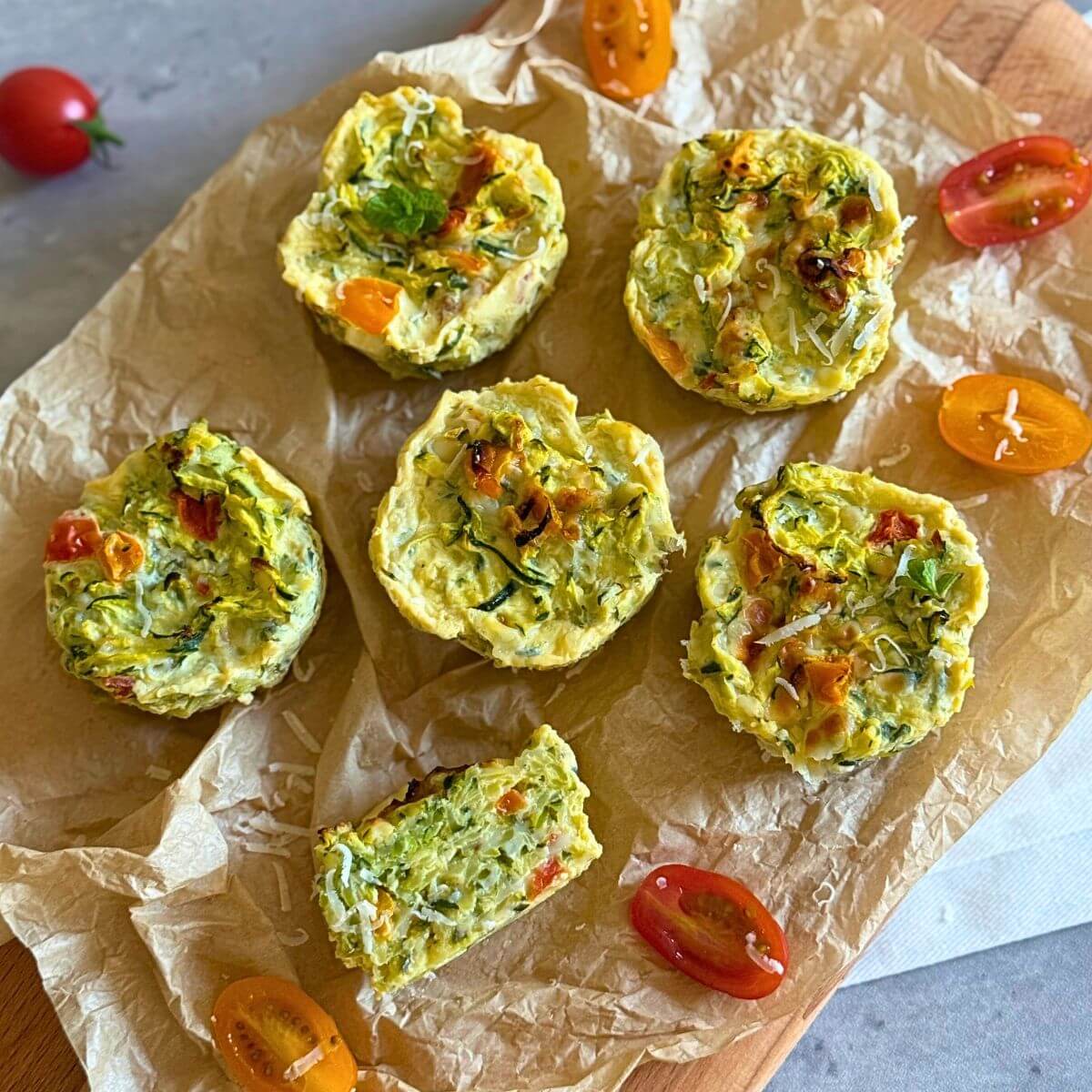 Gluten-free zucchini egg muffins on a wooden board.
