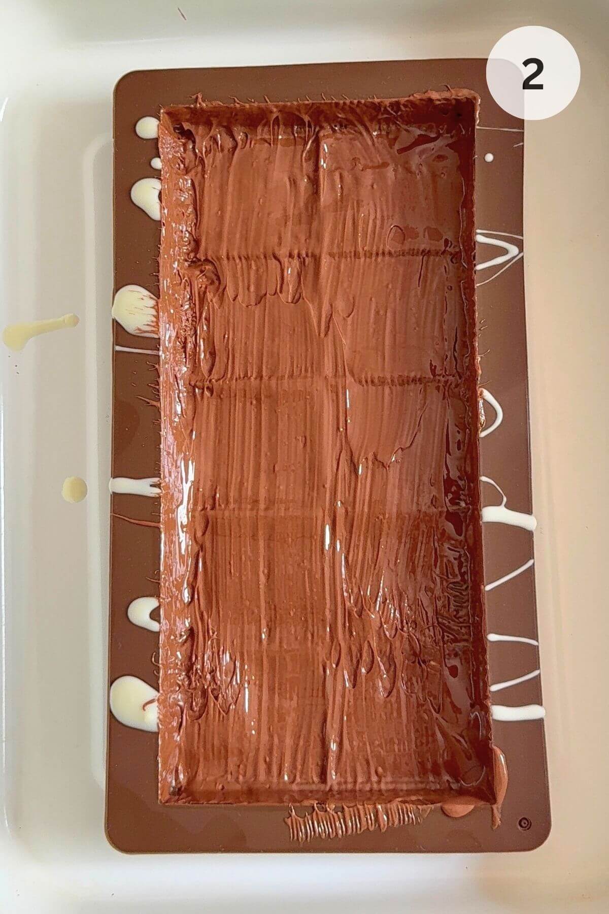 Milk chocolate poured into the mould, brushed up the sides.