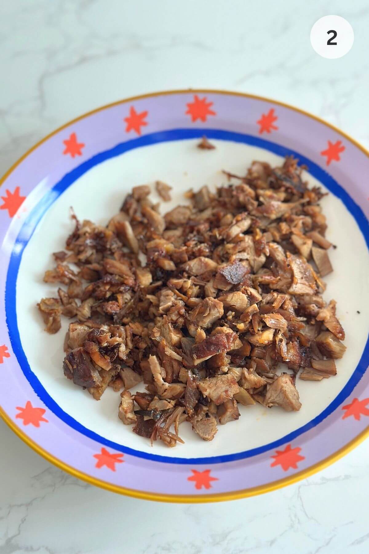 Crispy browned lamb pieces with caramelized edges on a plate. 