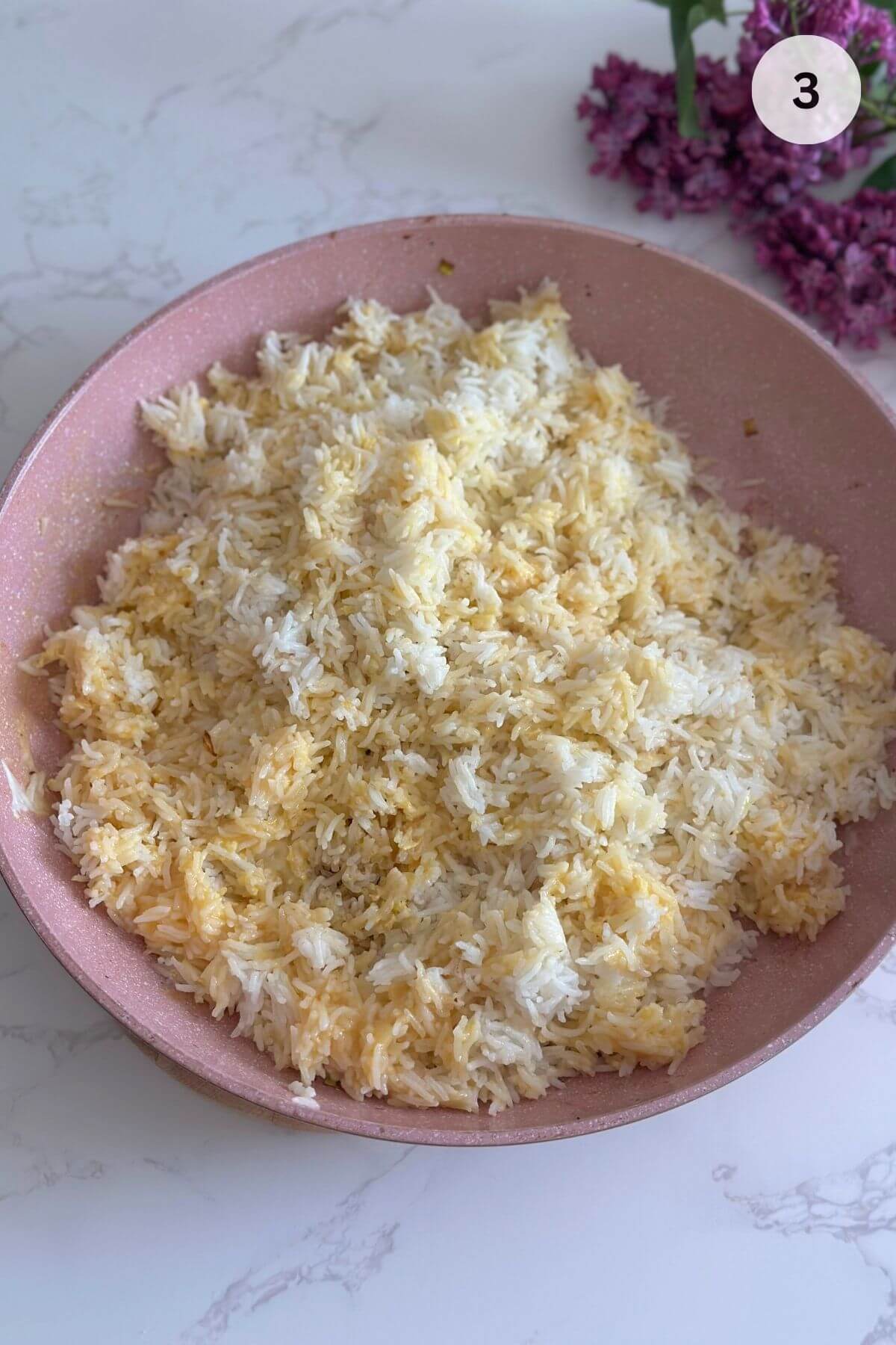 Cold rice and beaten eggs mixing in a wok.