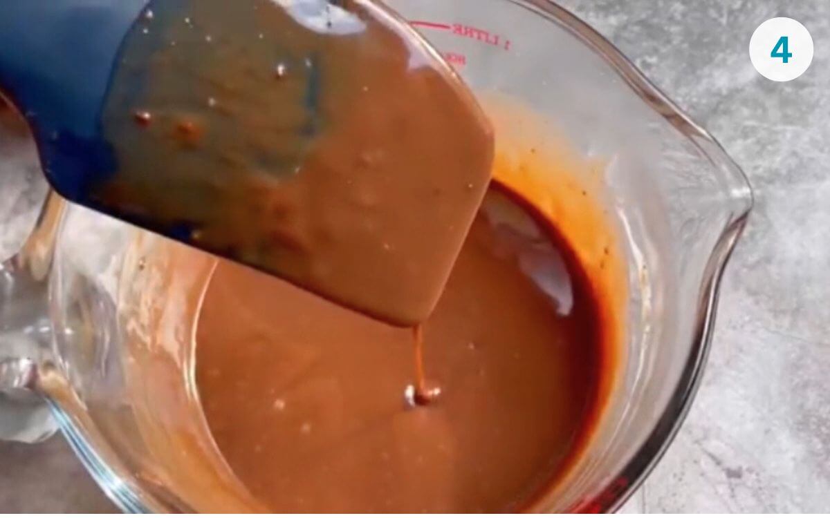 Smooth Nutella ganache in a bowl, ready to serve with pancakes, waffles, or cake.