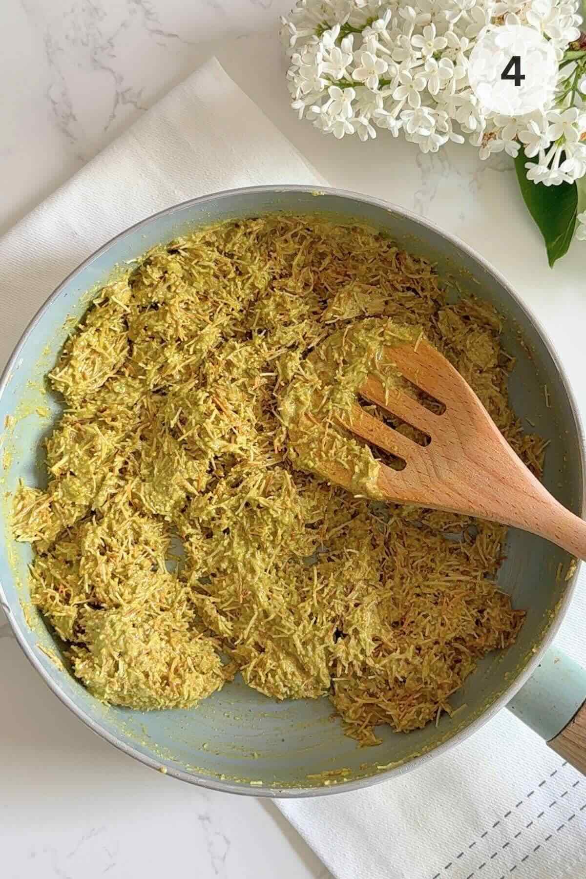 Melted butter, kataifi, pistachio butter, and tahini mixed in a skillet.