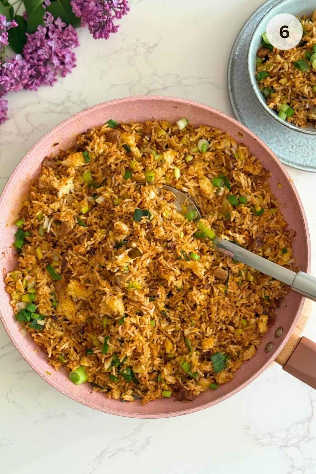 Finished lamb fried rice topped with green onions.