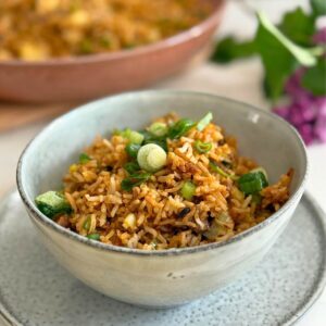 Leftover lamb fried rice served in a bowl with green onions.