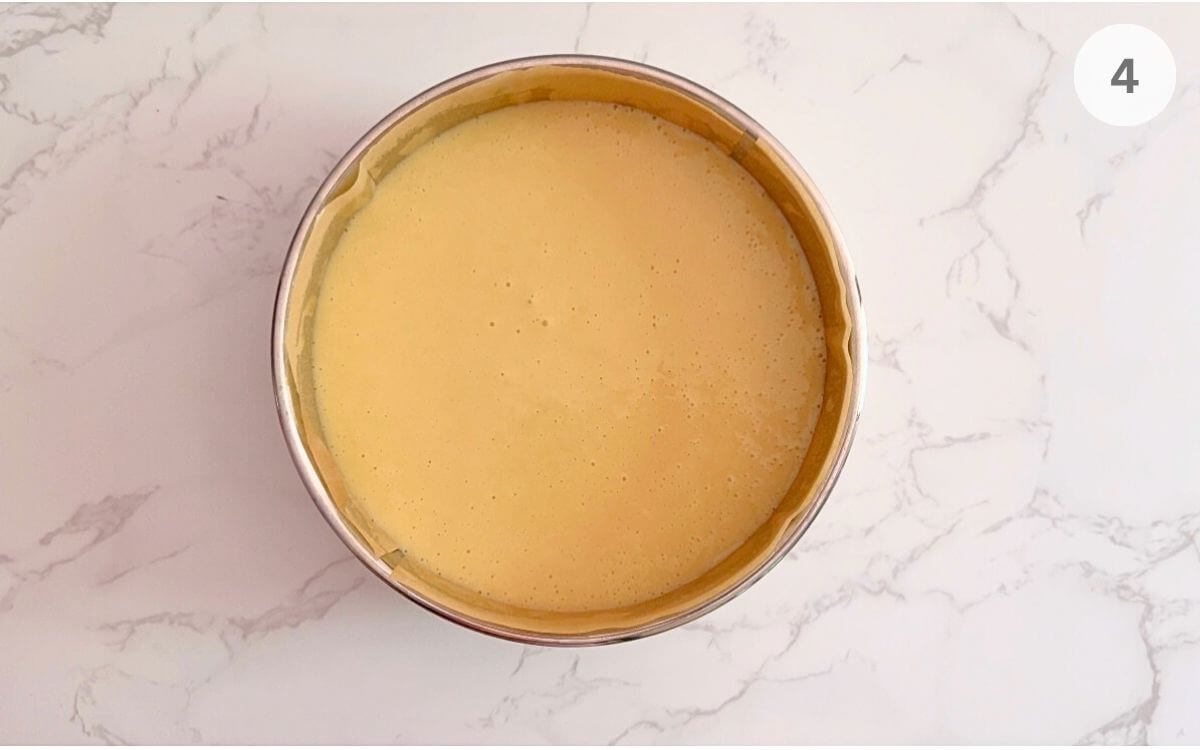 Cake batter divided evenly in pans, ready for baking.