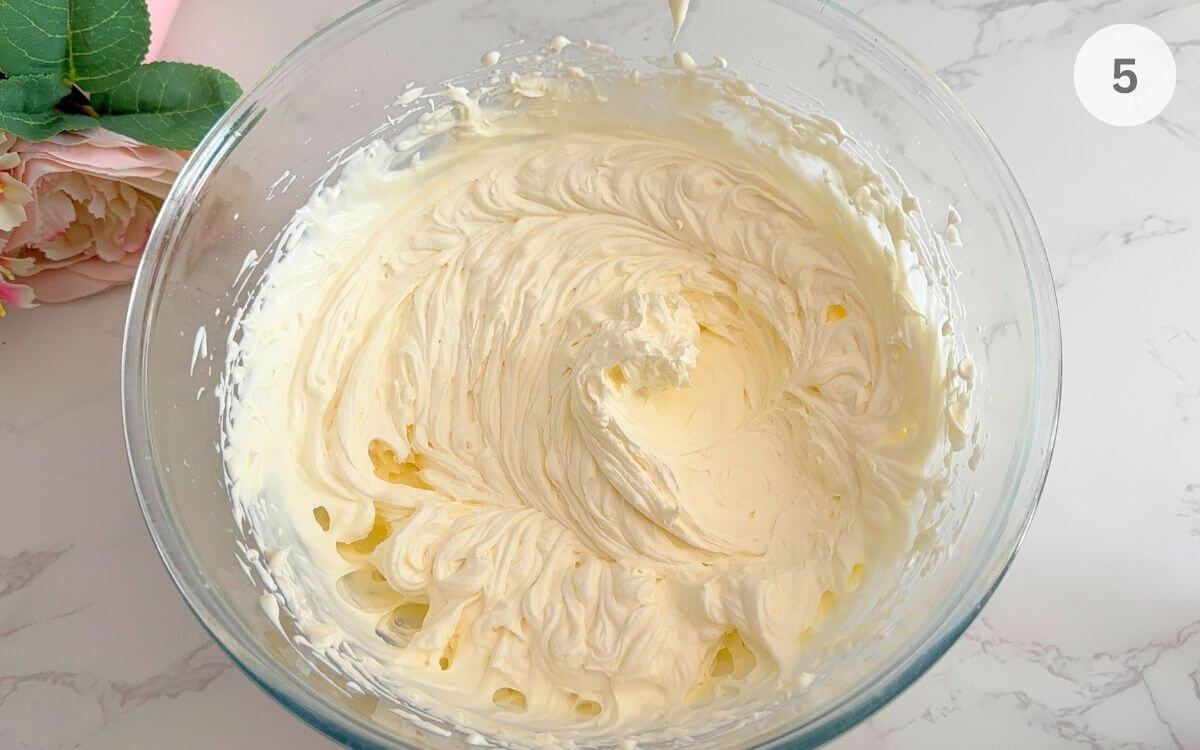 Cold cream whipped with powdered sugar and vanilla until soft peaks form.