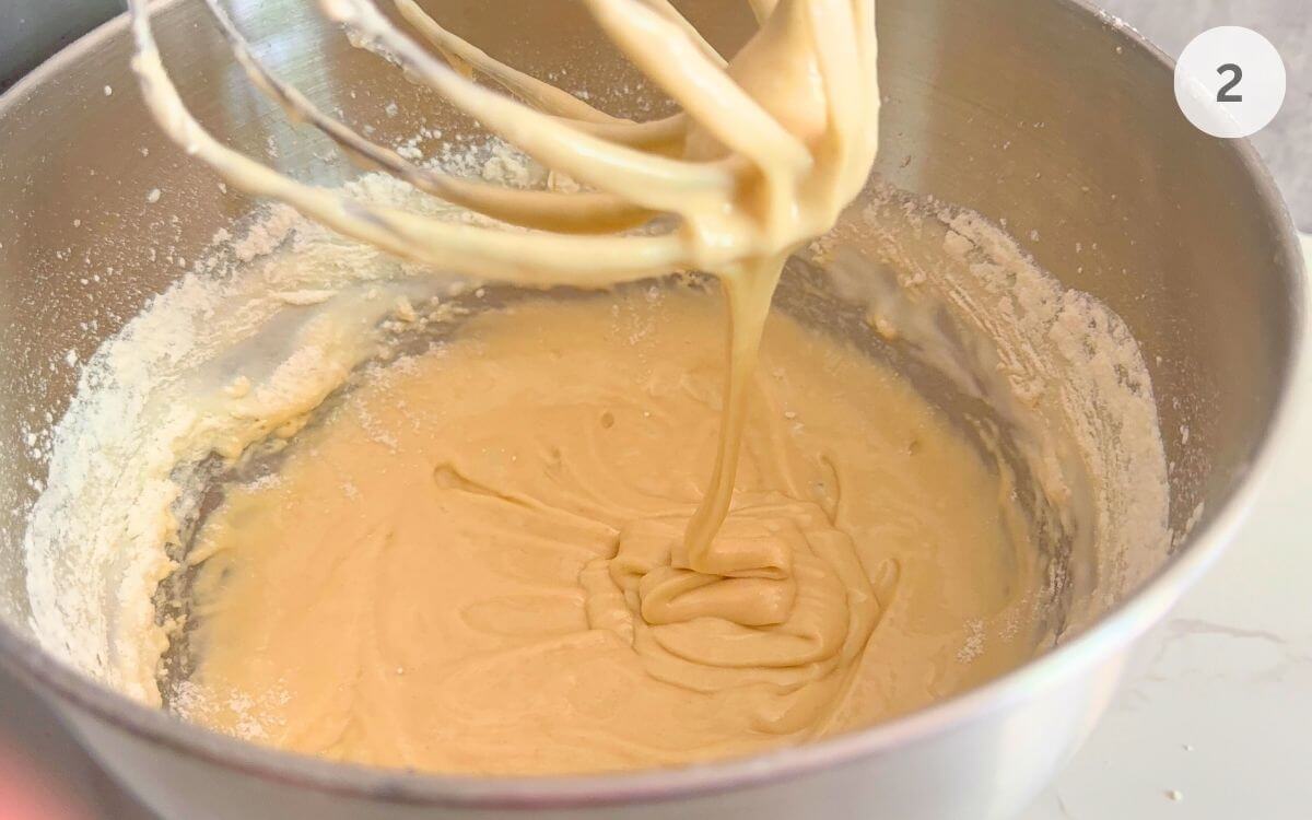 Dry ingredients partially mixed into the beaten eggs and sugar.