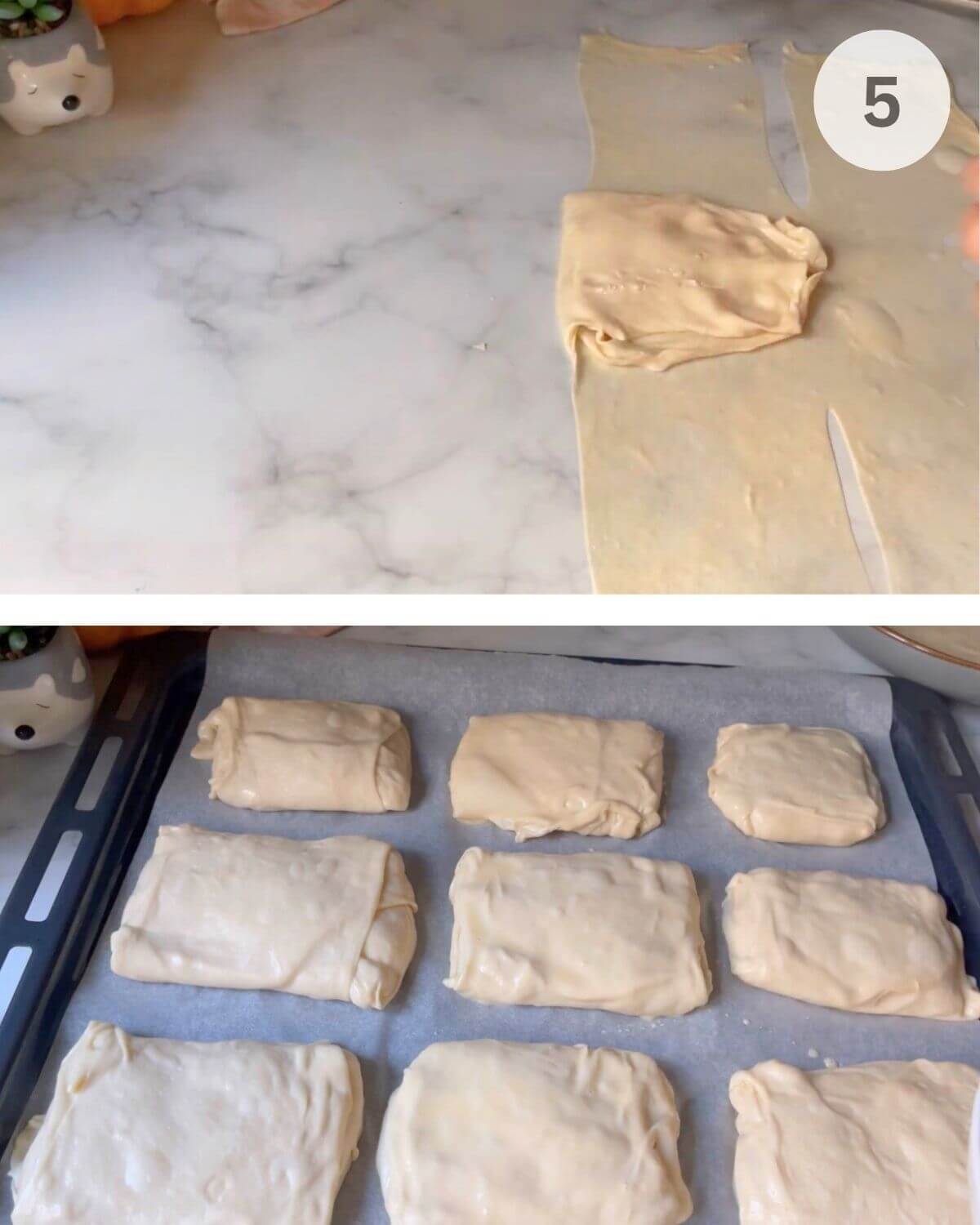 Pastries on a parchment-lined tray brushed with egg wash and sprinkled with seeds.
