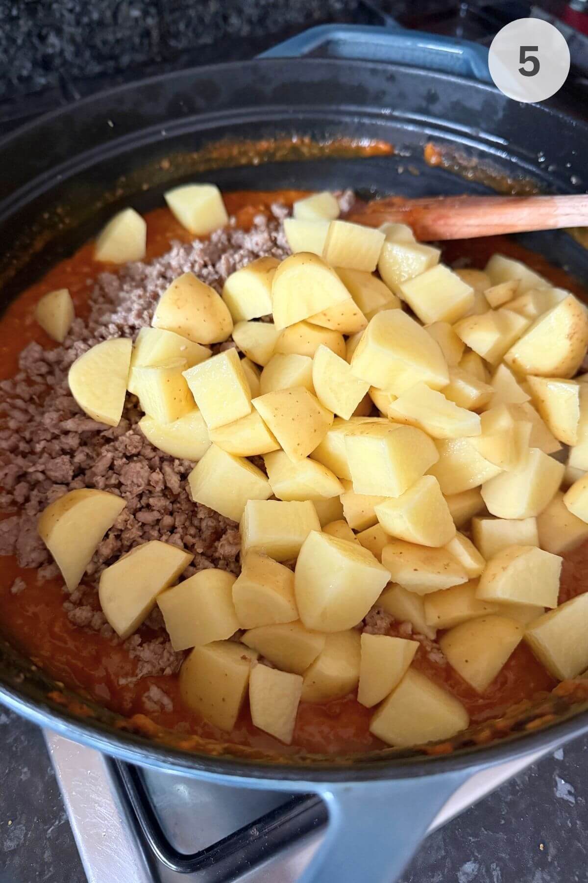 Cubed potatoes added to the pan, over the sauce and browned turkey mince. 
