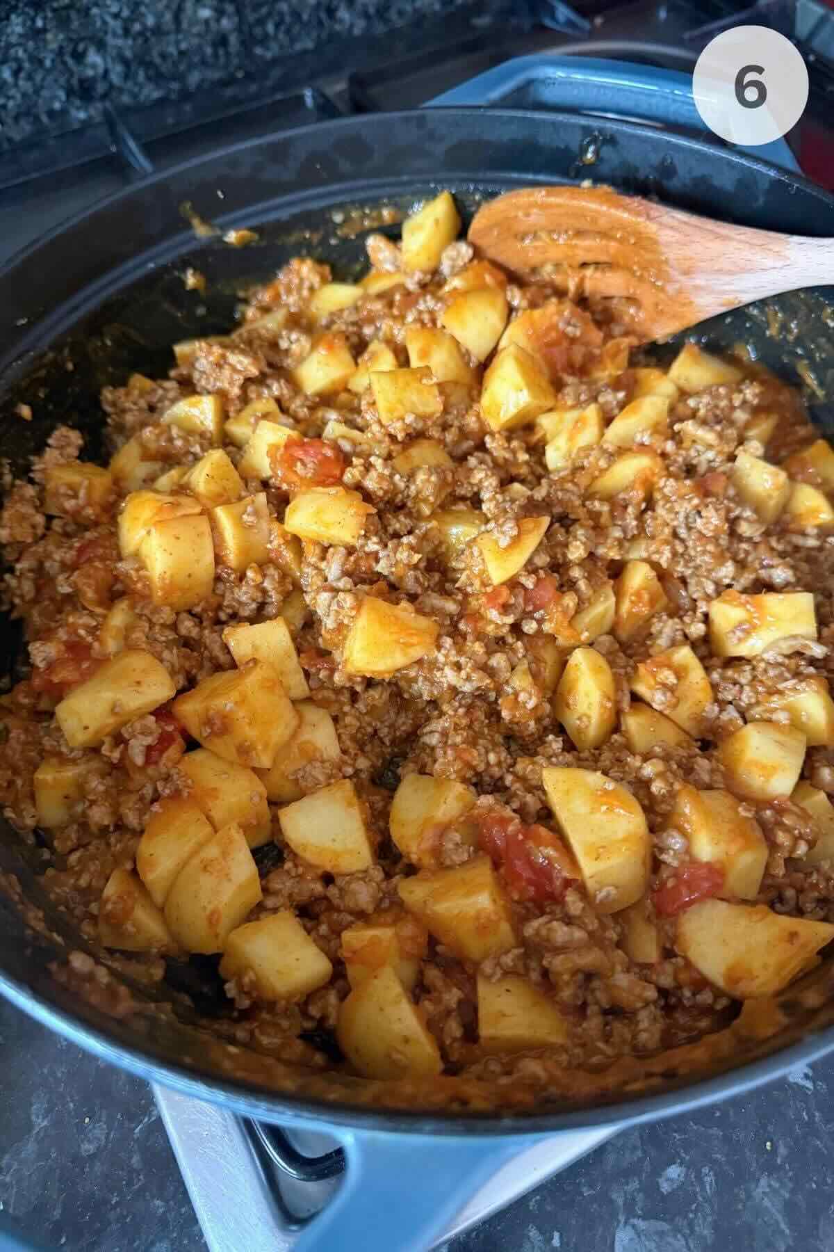 Cubed potatoes added to the pan, coated in curry spices and stirred with turkey.
