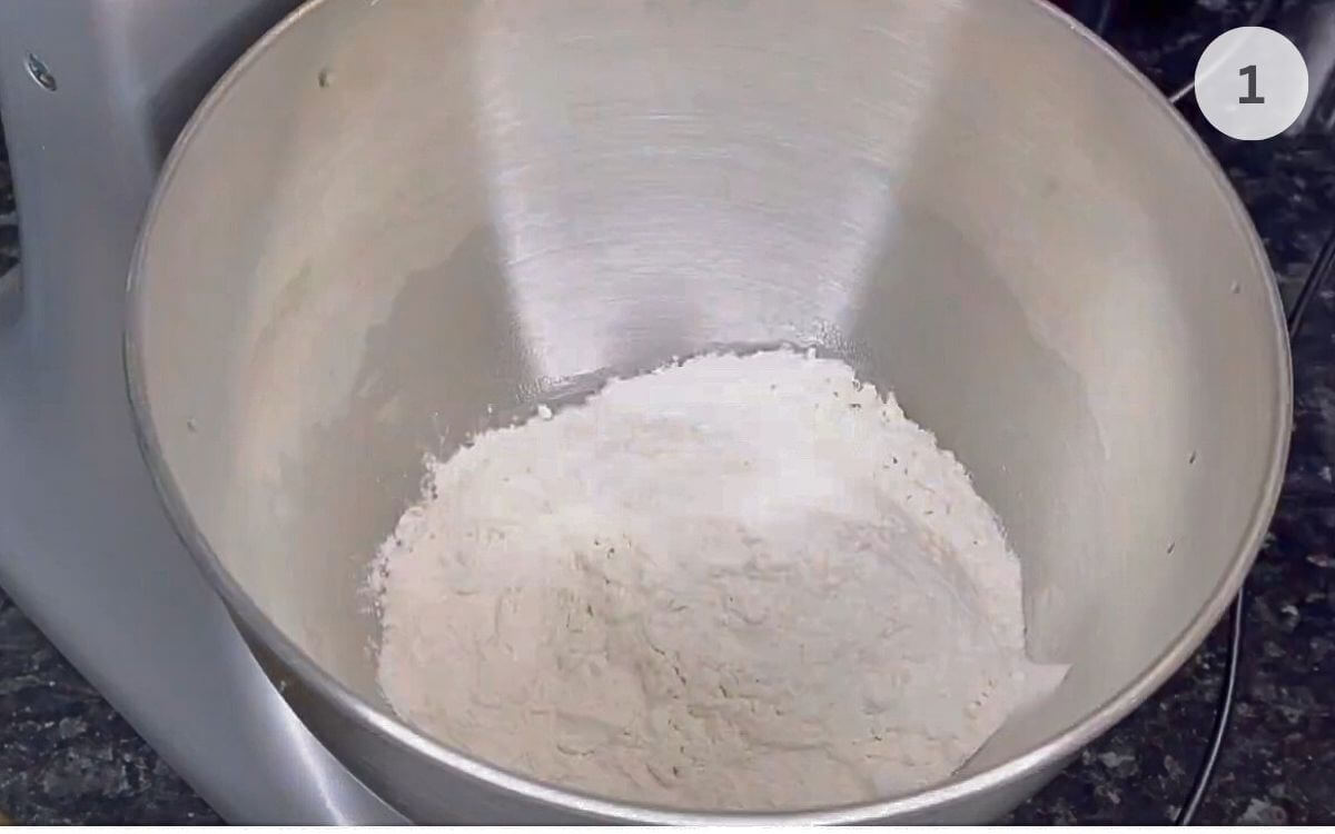 Flour added to a large mixing bowl.