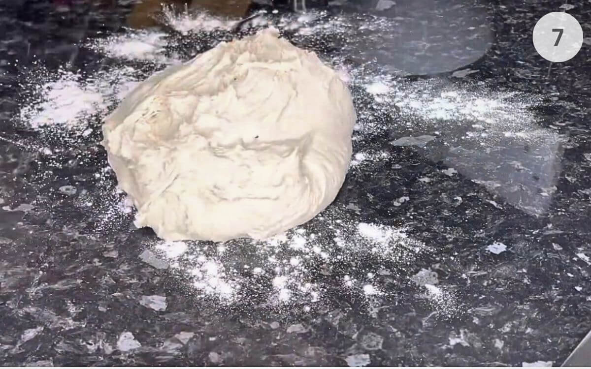 Dough turned out onto a surface and kneaded by hand until smooth and elastic.