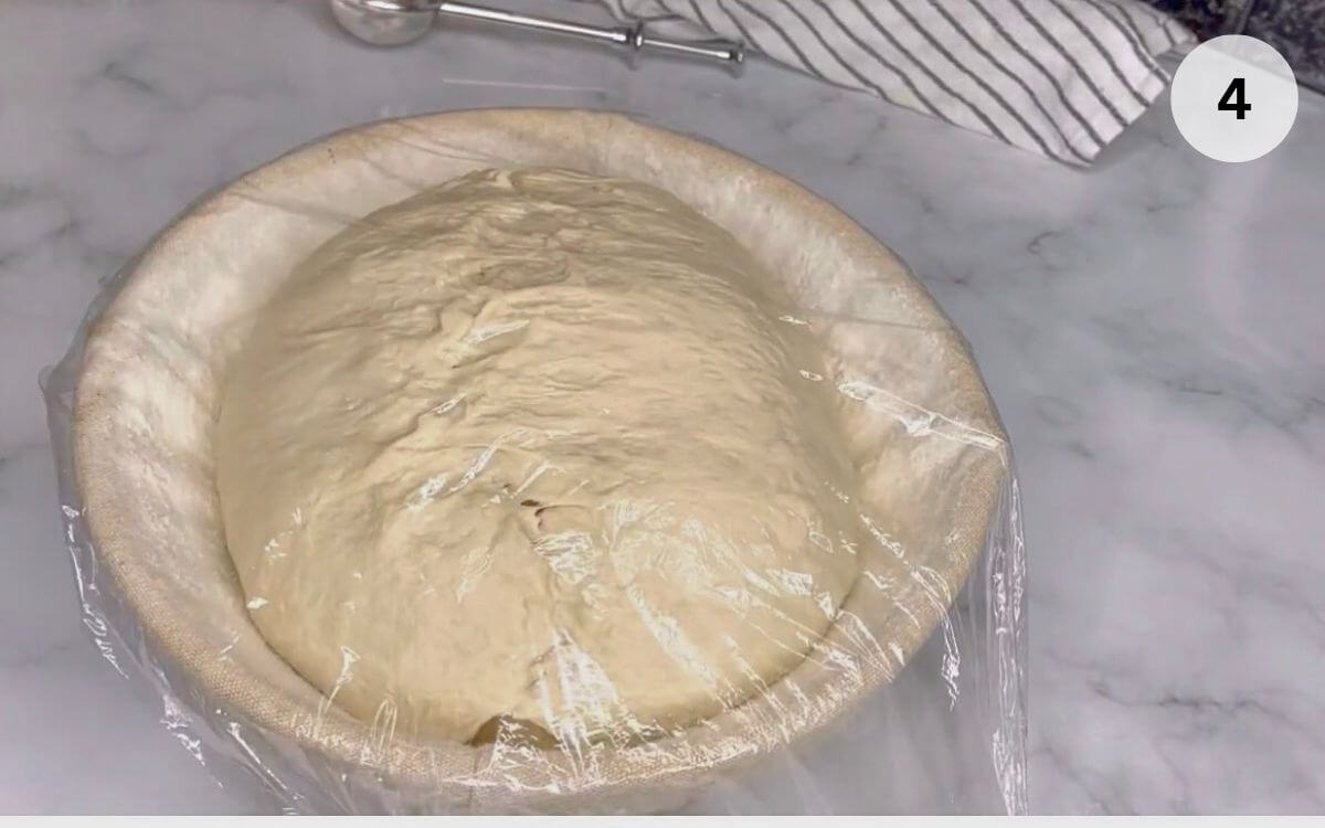Shaping the Romanian house bread into a round loaf before the second rest.