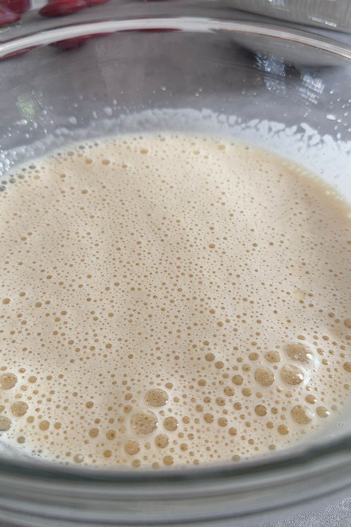 Fluffy, pale, and thickened egg and sugar mixture after whisking, ready for making moist plum cake batter.