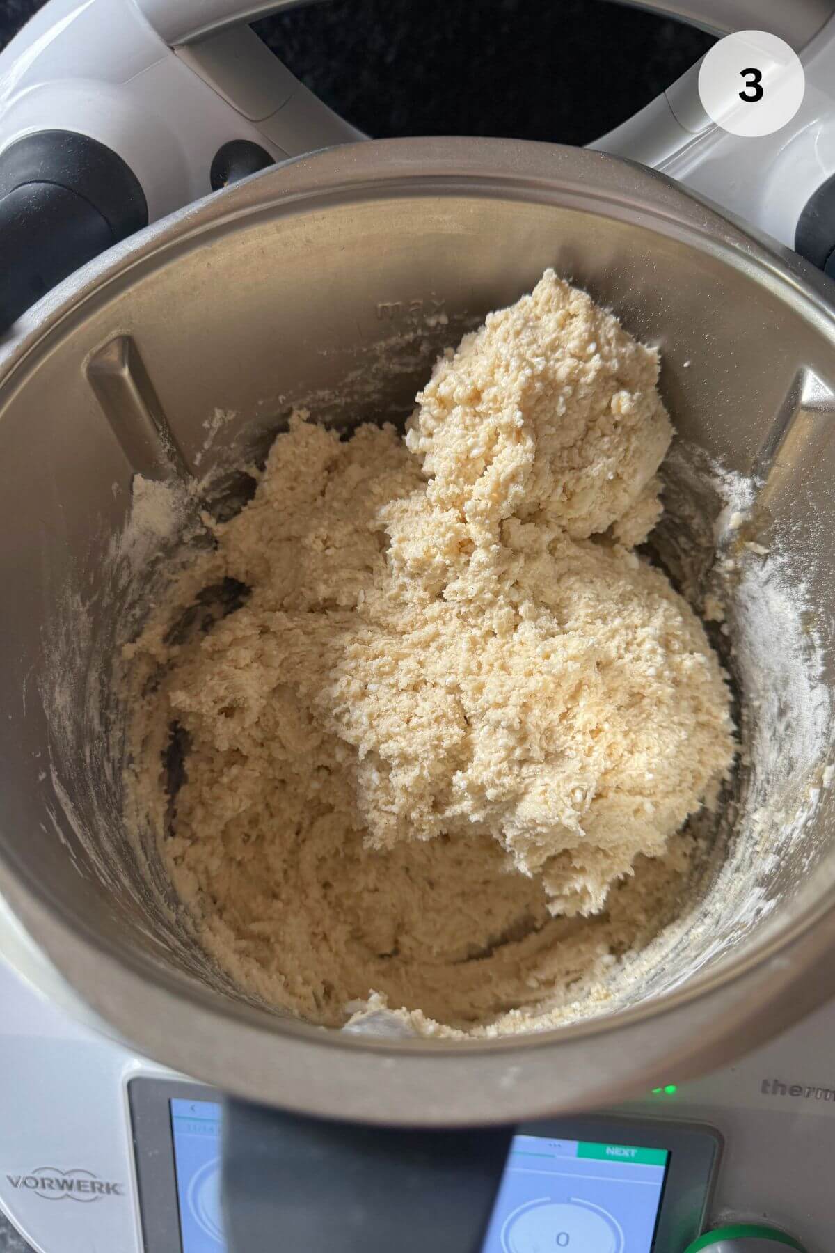 Mixing baking soda and flour into cottage cheese dough for baked papanasi.
