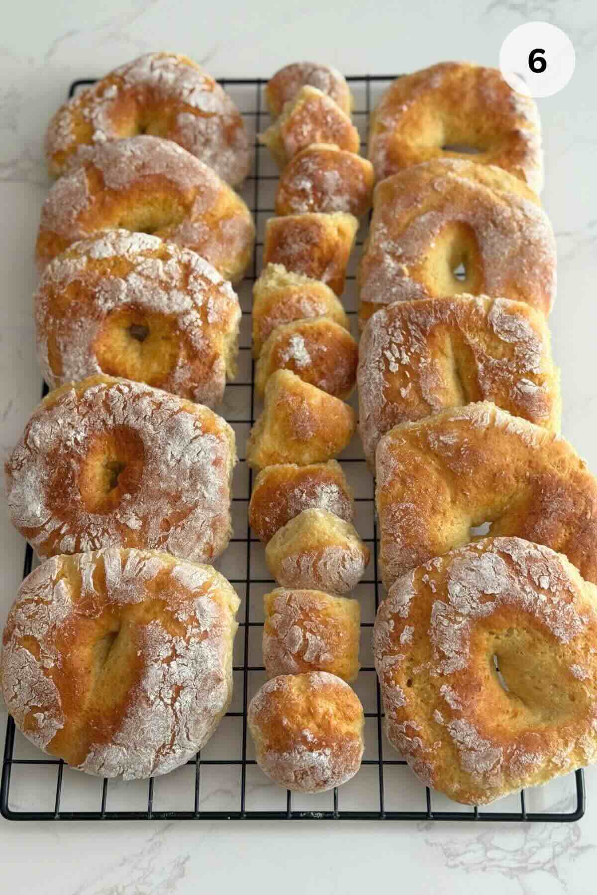 Baked papanasi cooling on a rack, can be served with sour cream and jam