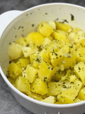 A ceramic pot of old fashioned parsley buttered potatoes.