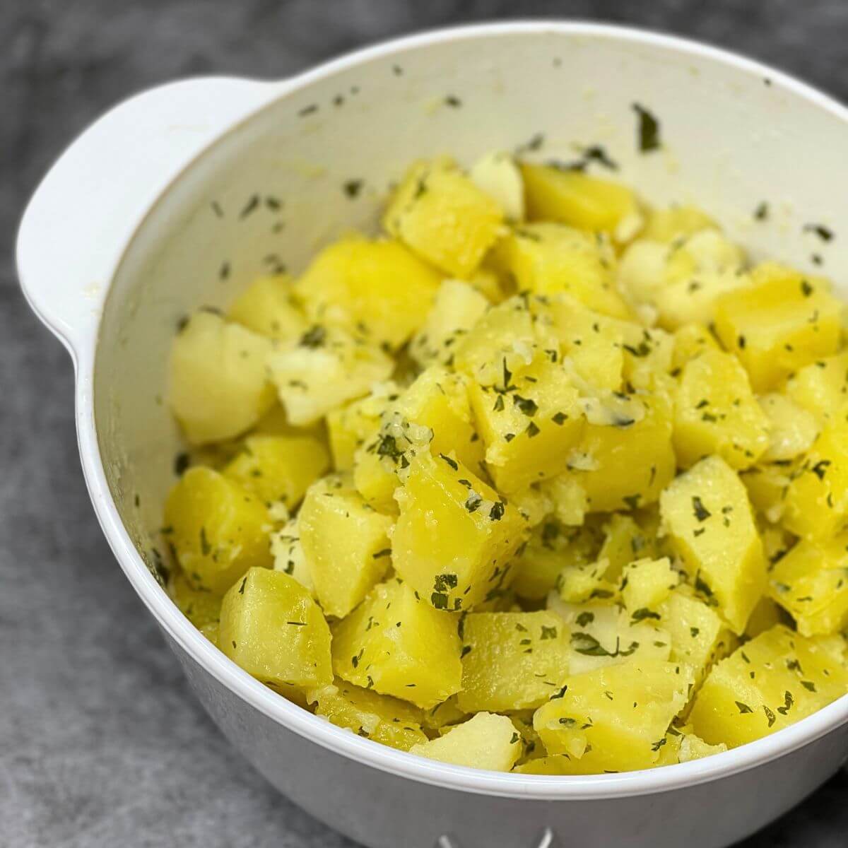 A ceramic pot of old fashioned parsley buttered potatoes.