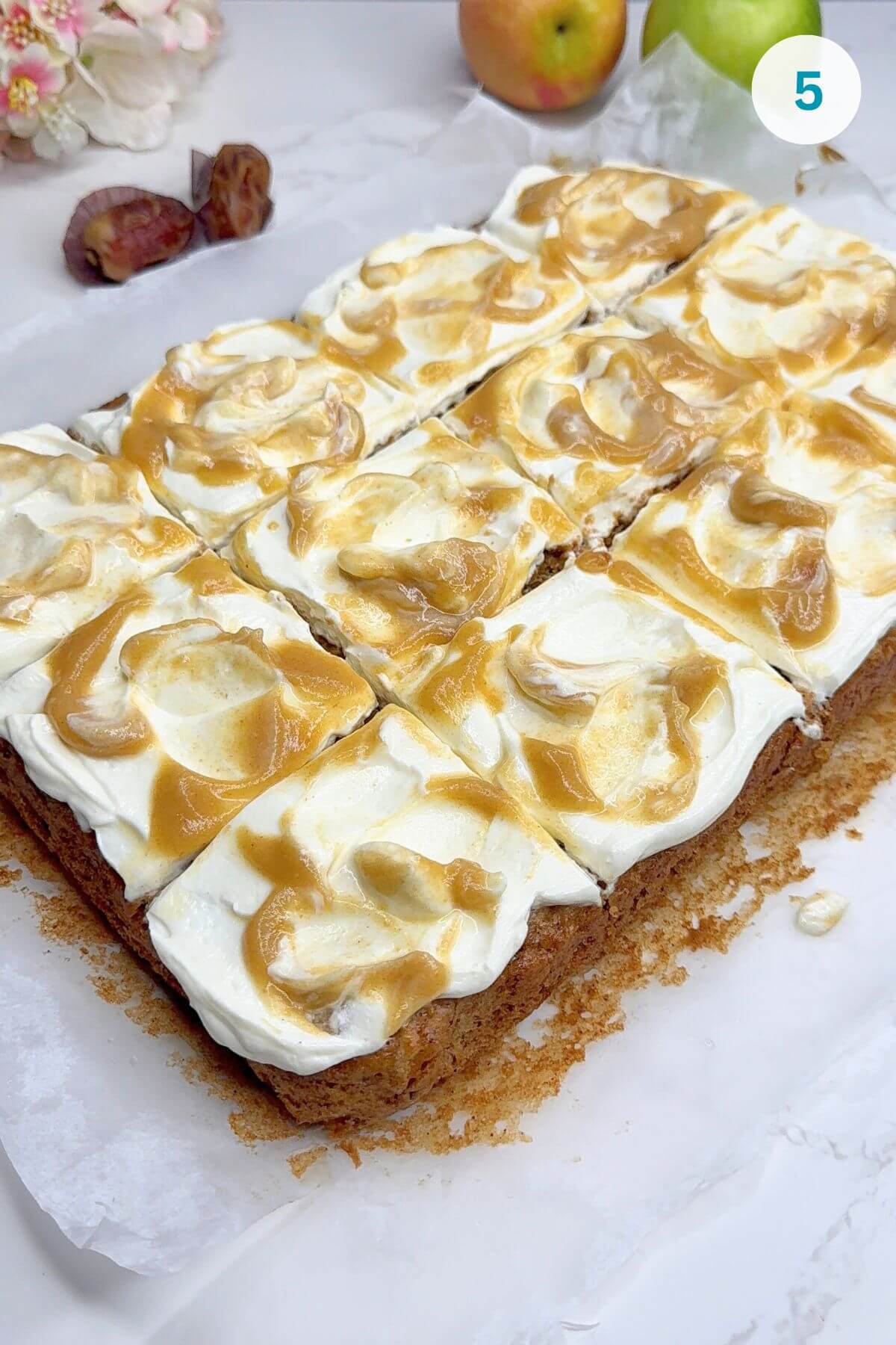 Vegan date caramel sauce drizzled generously over the frosted cake.